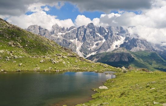 summer view of Lusia lakes with Pale San Martino mount on background in Italian dolomites. Photo taken with polarized filter
