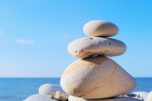 Three white pebbles on the sea coast