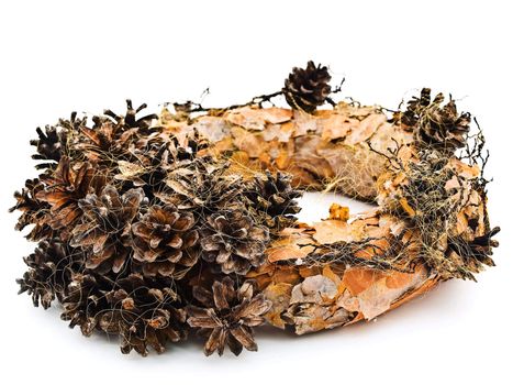 Handmade garland from pine tree rind and cones against the white background