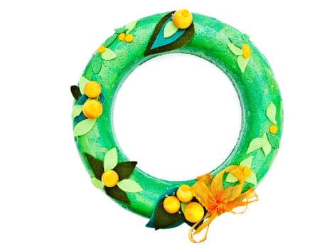 handmafe green garland from decorative materials against the white background