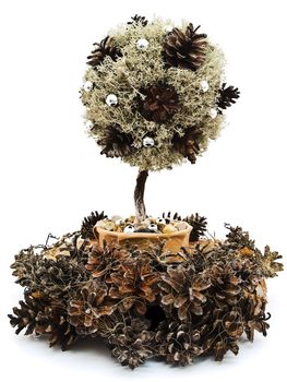 Handmade decorative tree into garland from pine tree rind and cones against the white background