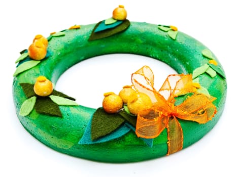 Photo of handmafe green garland from decorative materials against the white background