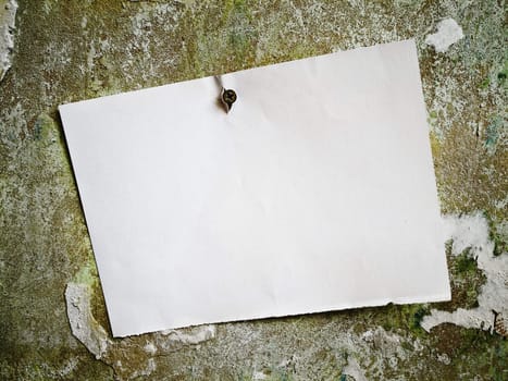 white template at screw-bolt in abstract grunge shabby background with rusty n green and light brown