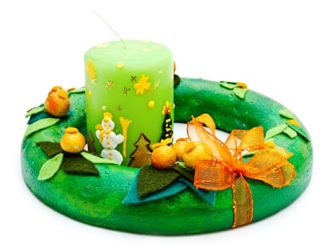 handmafe green garland from decorative materials with candle against the white background