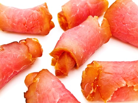 Close up photo of the red tasty smoked rolled meat against the white background 