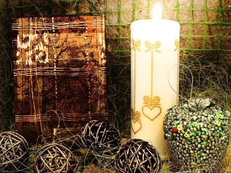 mysterious New Year composition with gift, candle and toys against abstract background