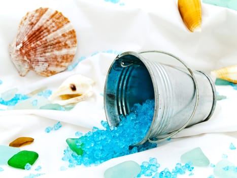marine decor with sea shells, bucket and decorative stones at white