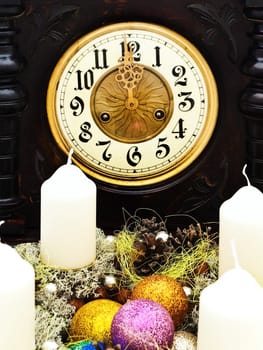New Year composition with old clock and garland with candles 