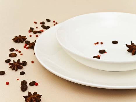 table serving with  anise stars, red pepper and coffee beans at beige tablecloth