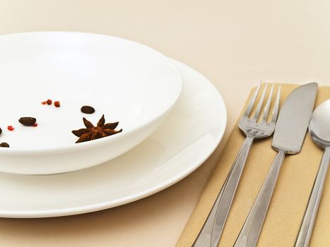 table serving with  anise stars, red pepper, coffee beans at beige tablecloth