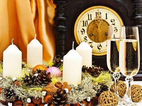 New Year composition with old clock, champagne, balls and garland with candles  