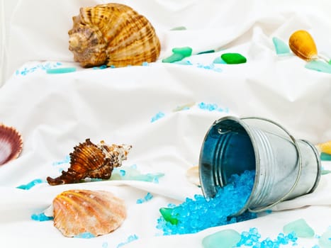 Photo of marine decor with sea shells, bucket and decorative stones at white 
