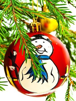 New Year red toy with snowman at fir tree brunch 
