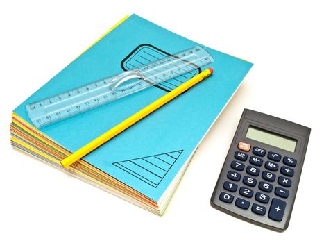 Notebooks stack with ruler and pencil near calculator against the white background  