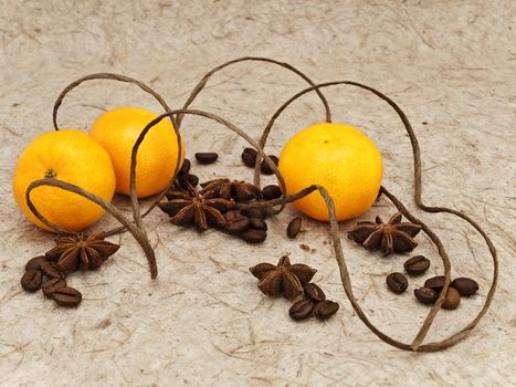 decoration with mandarins, anise stars and coffee beans against beige background