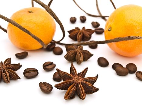 decoration with mandarins, anise stars and coffee beans against white background