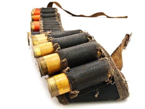 Photo of old cartridge in leather belt for hunting rifle against white background