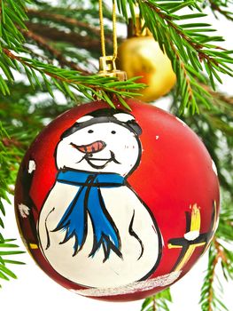 New Year red toy with snowman at fir tree brunch
