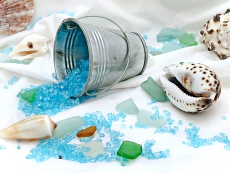marine decor with sea shells, bucket and decorative stones at white