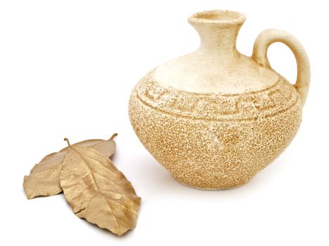 ancient beige vase and golden bay leaves against white background