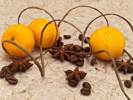 decoration with mandarins, anise stars and coffee beans against beige background
