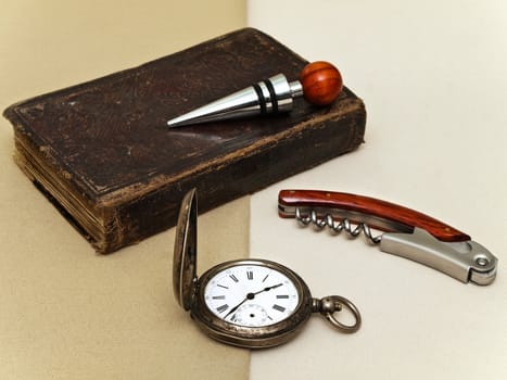 layout of clock, book, corkscrew and stopper