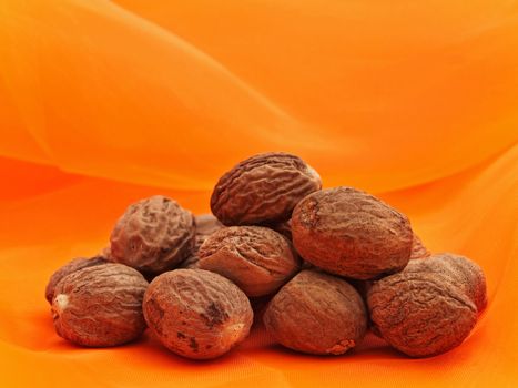 Photo of nutmeg stack at orange textile