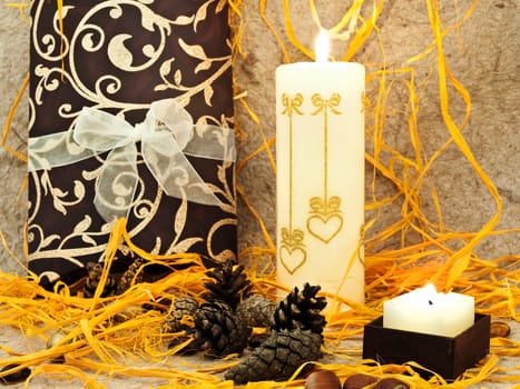  festive composition with gift, candle and cones against abstract background 