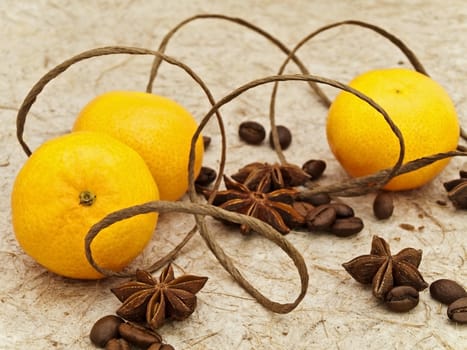 mandarins, anise stars and coffee beans against beige background