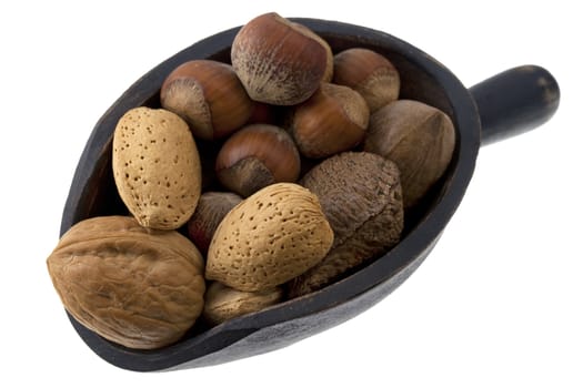 hazelnuts, almonds, pecans, walnuts and Brazilian nuts on a rustic wooden scoop isolated on white