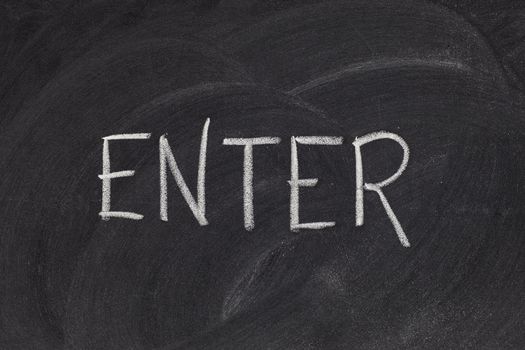 enter - white chalk handwriting on blackboard with eraser patterns