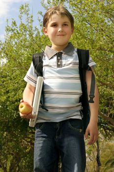 Pupil walking to school on a sunny day.  
