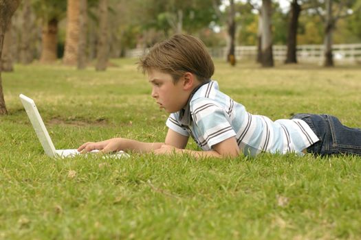 A relaxed child sdeen working on his computer