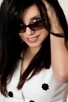 Beautiful young woman looking over the top of her sunglasses. eg, beauty, style, optomestrists, fashion accessories, designer looks...