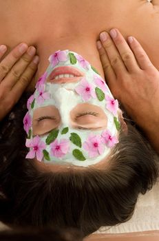 A woman enjoys a salon mask and massage