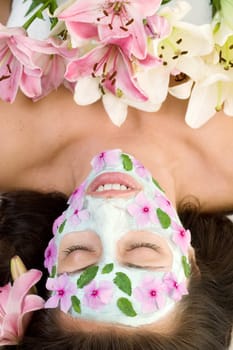 Woman with a botanical mask and flowers decoration