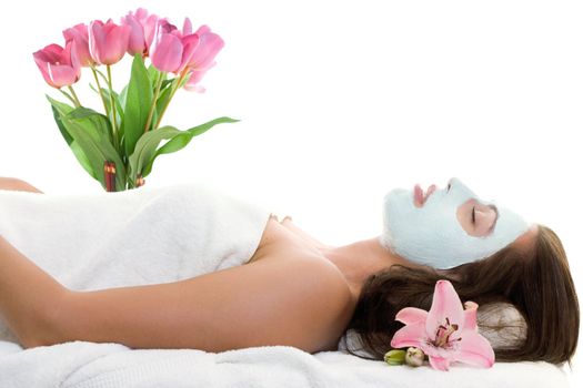 A relaxed young woman with a treatment facial.