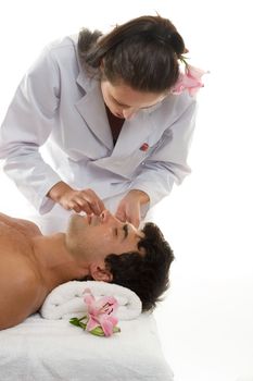 Beatician or esthetician treating a male client