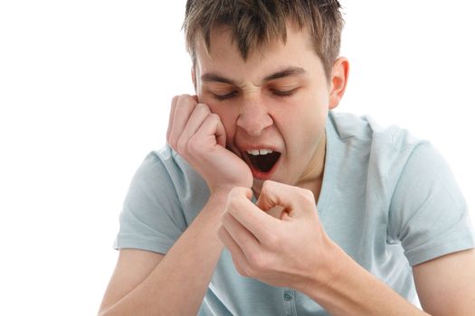 A boy yawning from tiredness, depression, apathy or boredom.  White background.