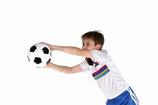 A young boy playing with a soccer ball.