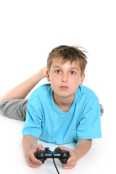 A boy on the floor playing a computer game.