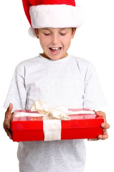 A delighted child holding a wrapped Christmas present.