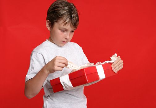 A child unwraps a birthday or Christmas present.