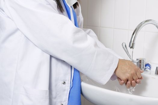 Doctor or a nurse or surgeon washing hands