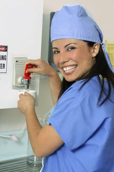 A medical staff makes a cup of tea or coffee in the staffroom.