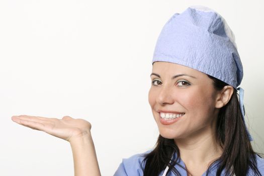 A female in medical unform with hand outstetched palm upwards ready for a product display, or other.