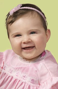 Baby girl in pink outfit and matching pink headband