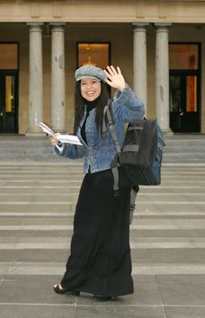 Back to School - A college or university student waving to friends
