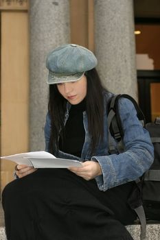 Student reading some papers, notes.
