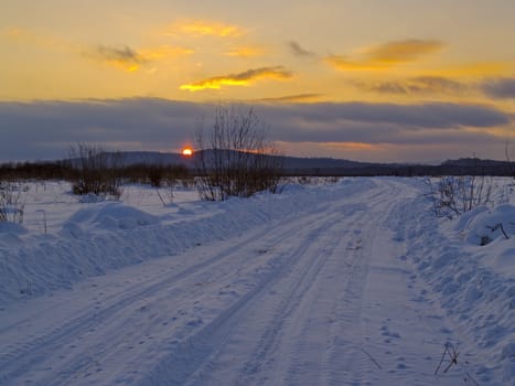Winter landscape with decline on a country road